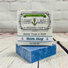 Picture of a box of Shart Wash Natural Handmade Bar Soap Deep Blue Sea Salt scent sitting on a blue bar of soap with a wood background