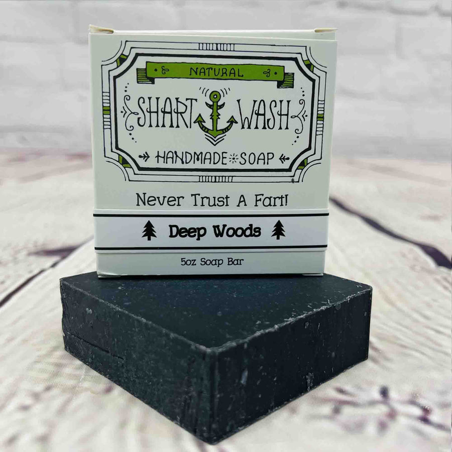 Picture of Shart Wash Handmade Soap Bars Deep Woods Scent box on top of a Black bar of soap