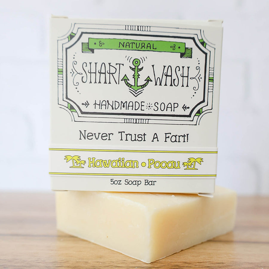 picture of a yellow bar of Hawaiian Pooau scent shart wash handmade soap on a wood background