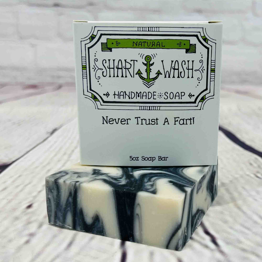 Picture of Shart Wash Handmade Soap Bars Skid Mark Scent box on top of a black and white bar of soap