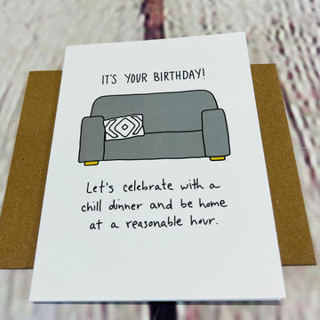 Front of the card showing a picture of a gray couch. Text says, 
