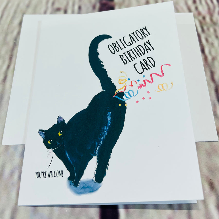 White birthday card with a picture of a black cat farting confetti. Top text: Obligatory Birthday Card. Bottom Text: Cat saying, 